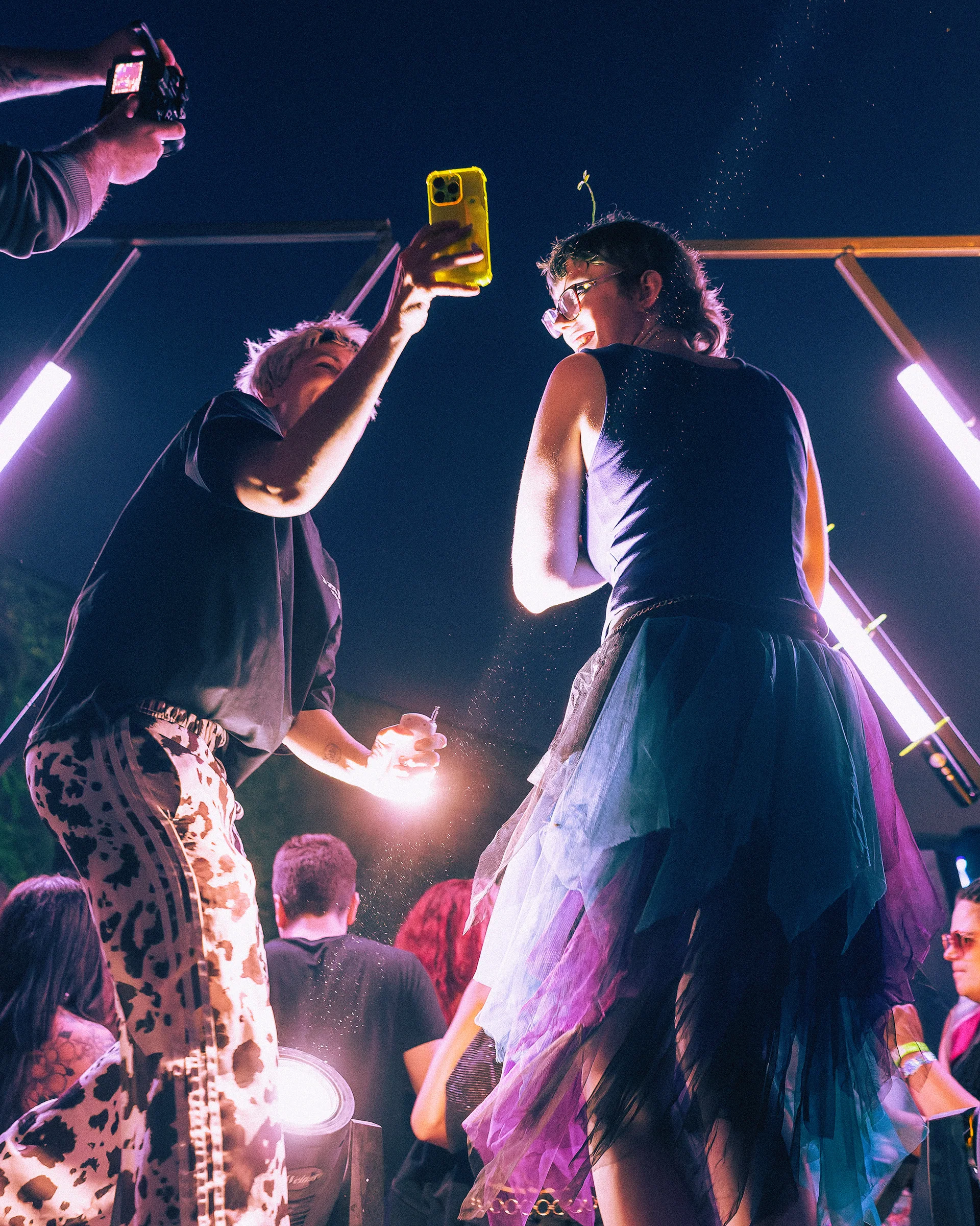 Backstage view of performers and guests in a busy event space.