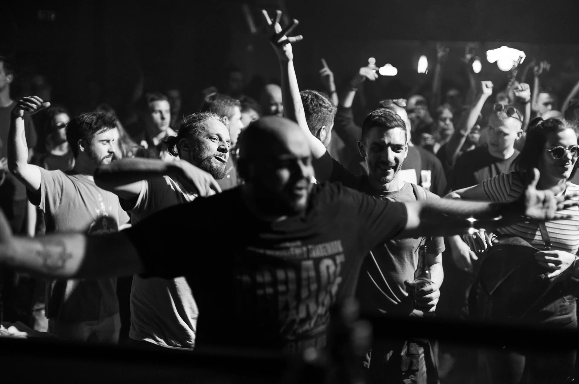 Black-and-white photograph of a tightly packed crowd at the barrier.