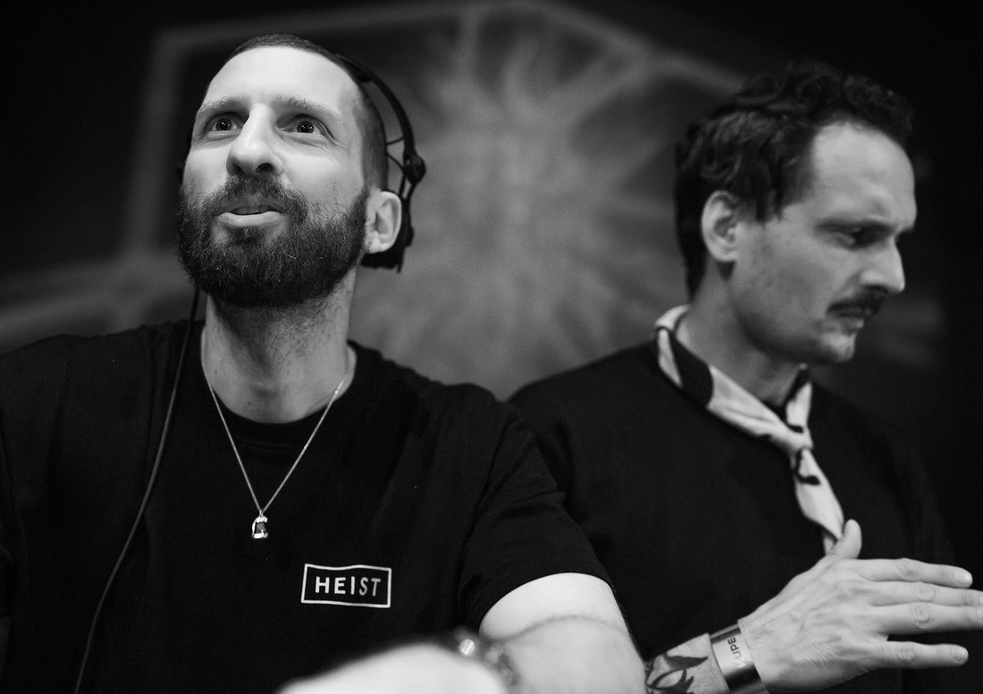 Two DJs photographed together in an intimate black-and-white portrait.