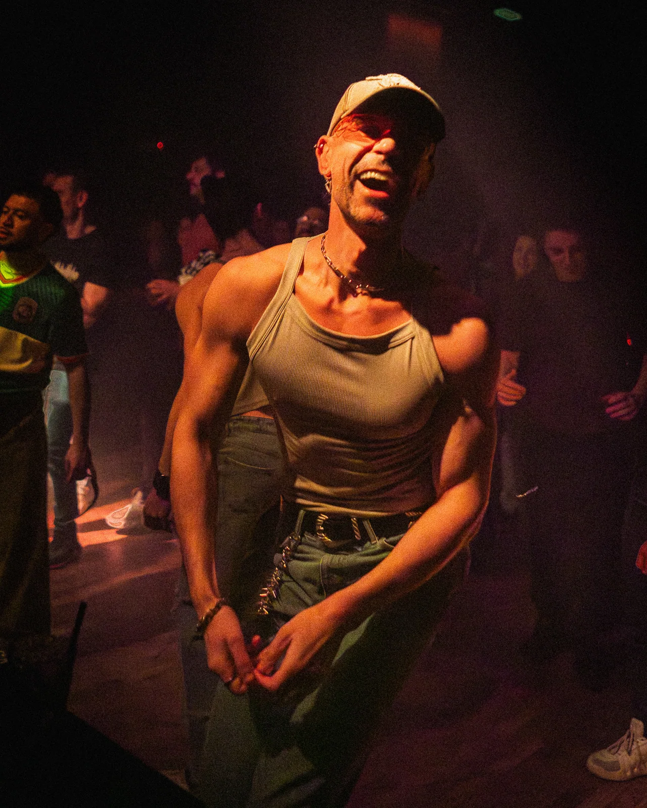 Performer smiling beside the crowd during a live show.