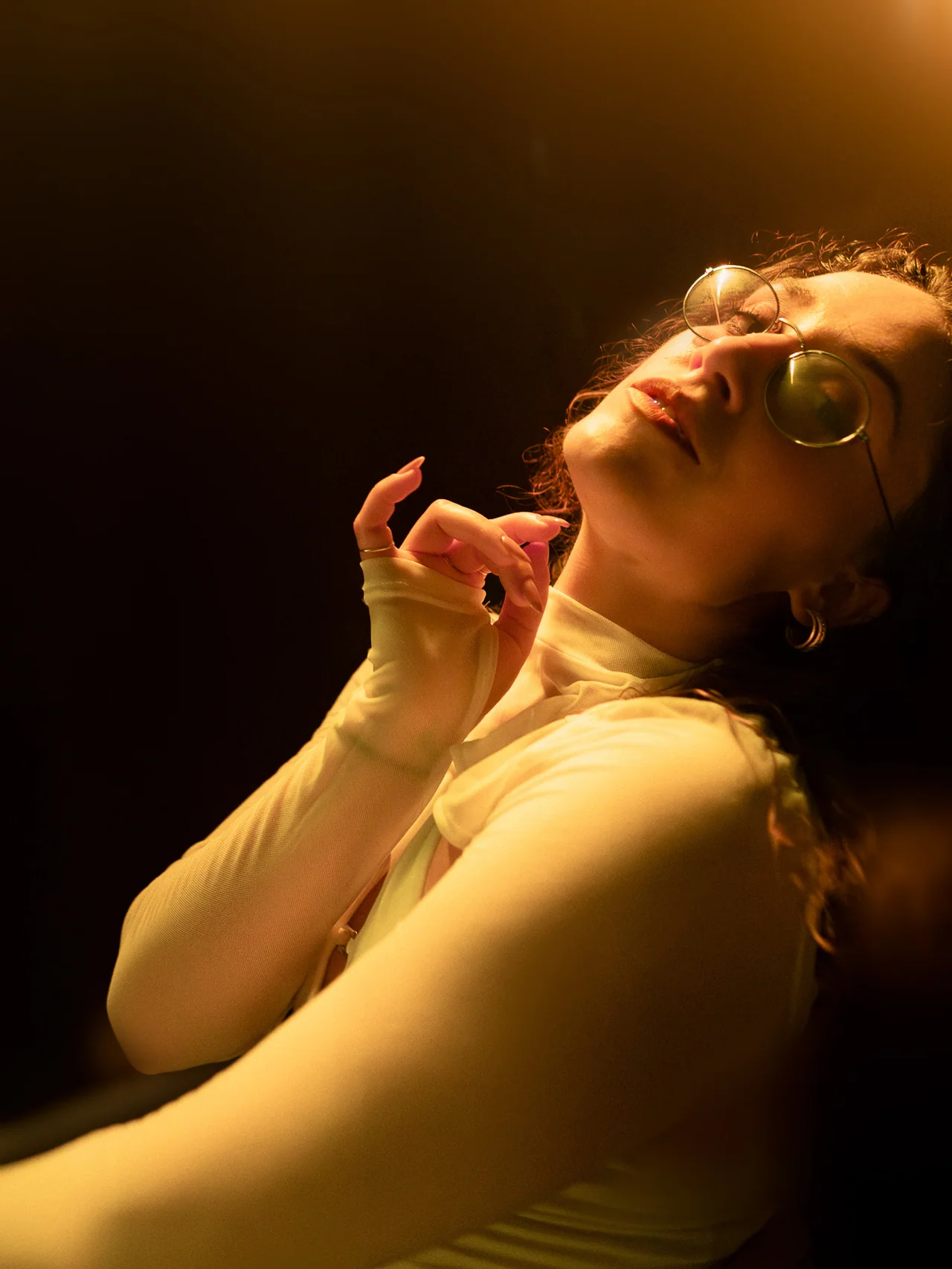 Intimate seated portrait of a guest in soft golden light.